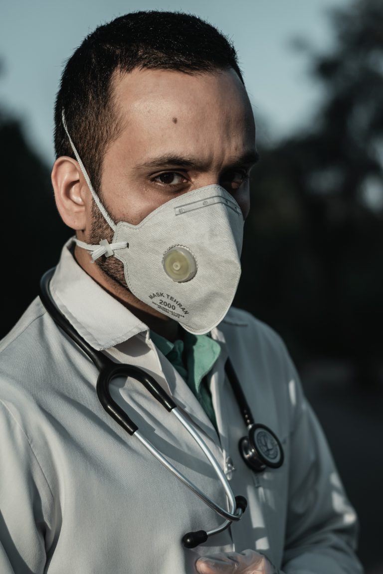 person wearing white and gray gas mask