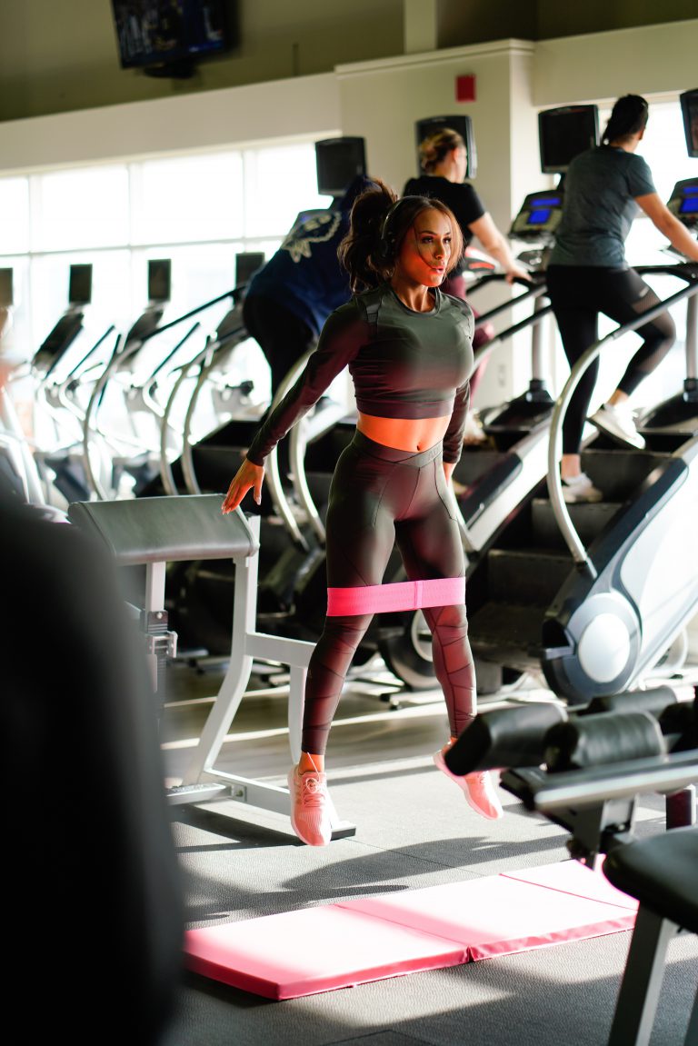 woman standing near treadmill lot