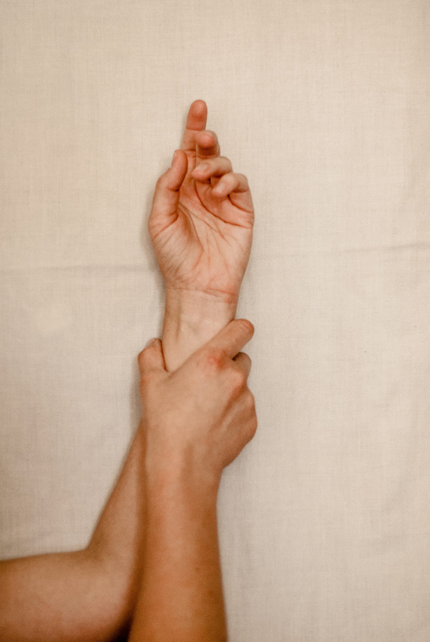 persons right foot on white textile