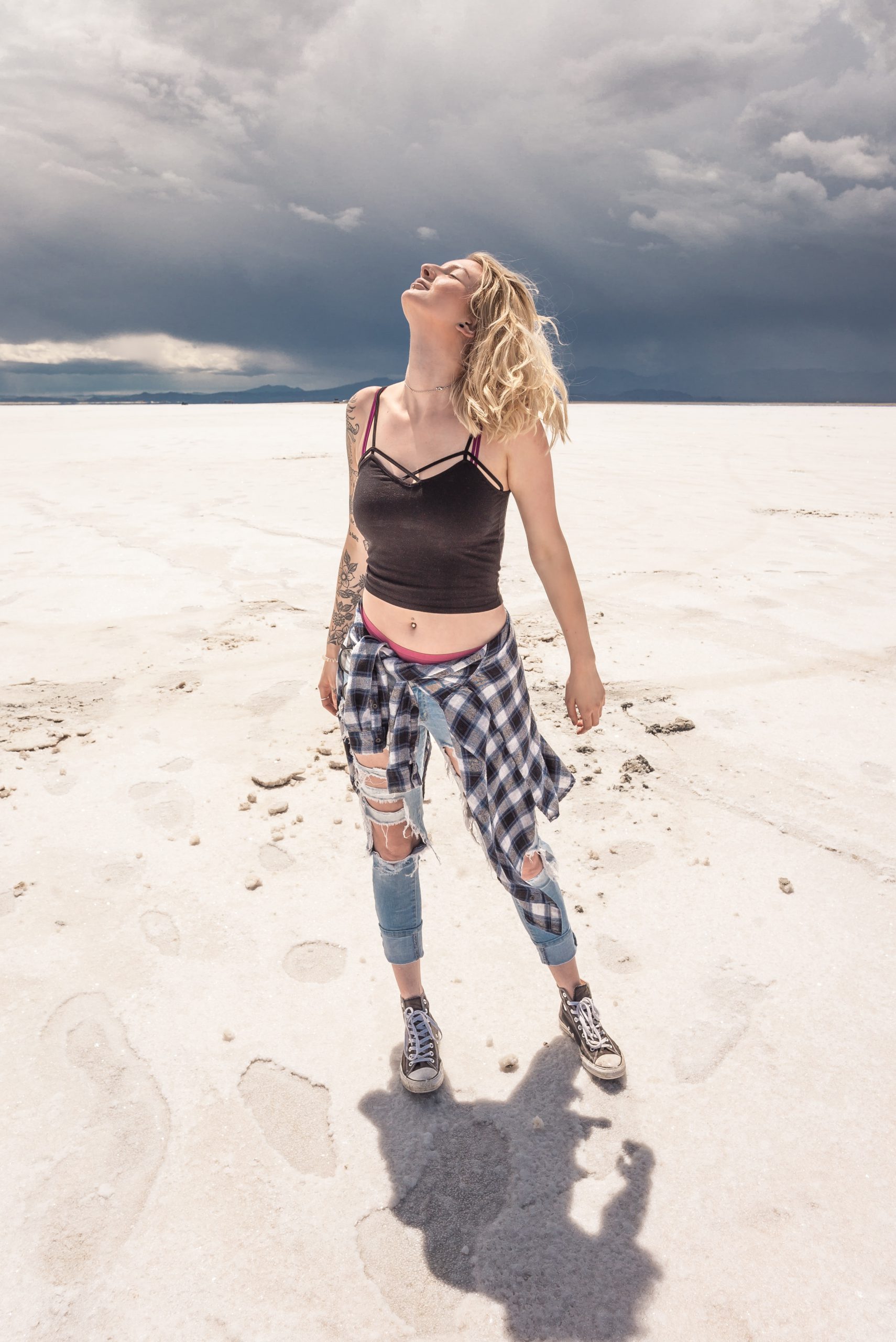 woman wearing black crop top standing on desert