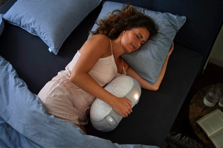 woman in white tank top lying on bed